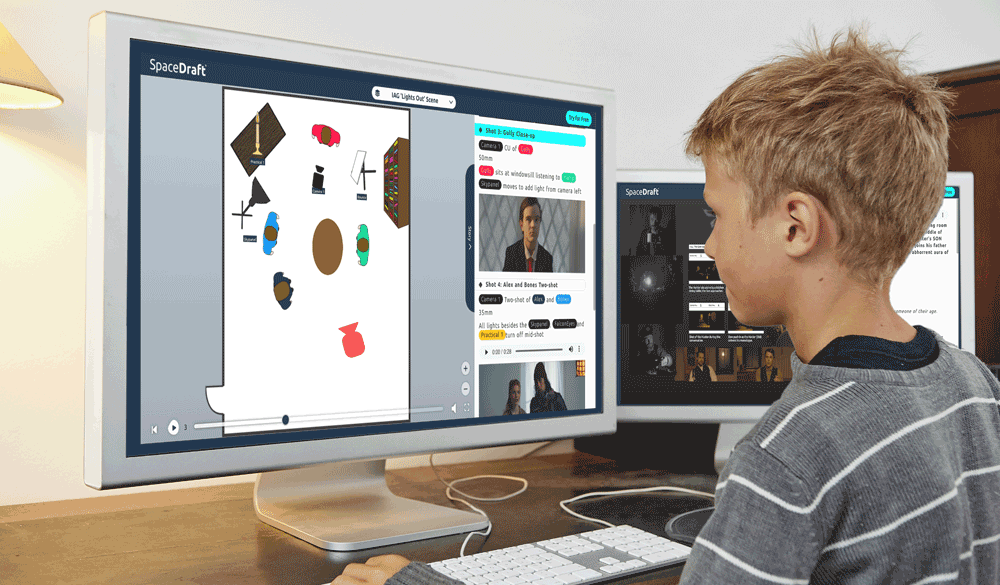A child looking at a computer screen that is displaying a SpaceDraft with people and film equipment.