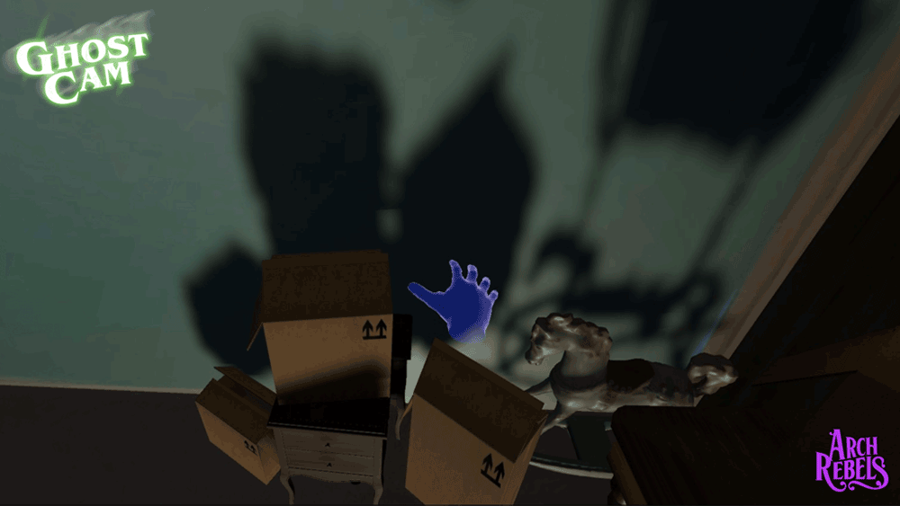 A screenshot from Ghost Cam showing a purple hand reaching out over packing boxes.